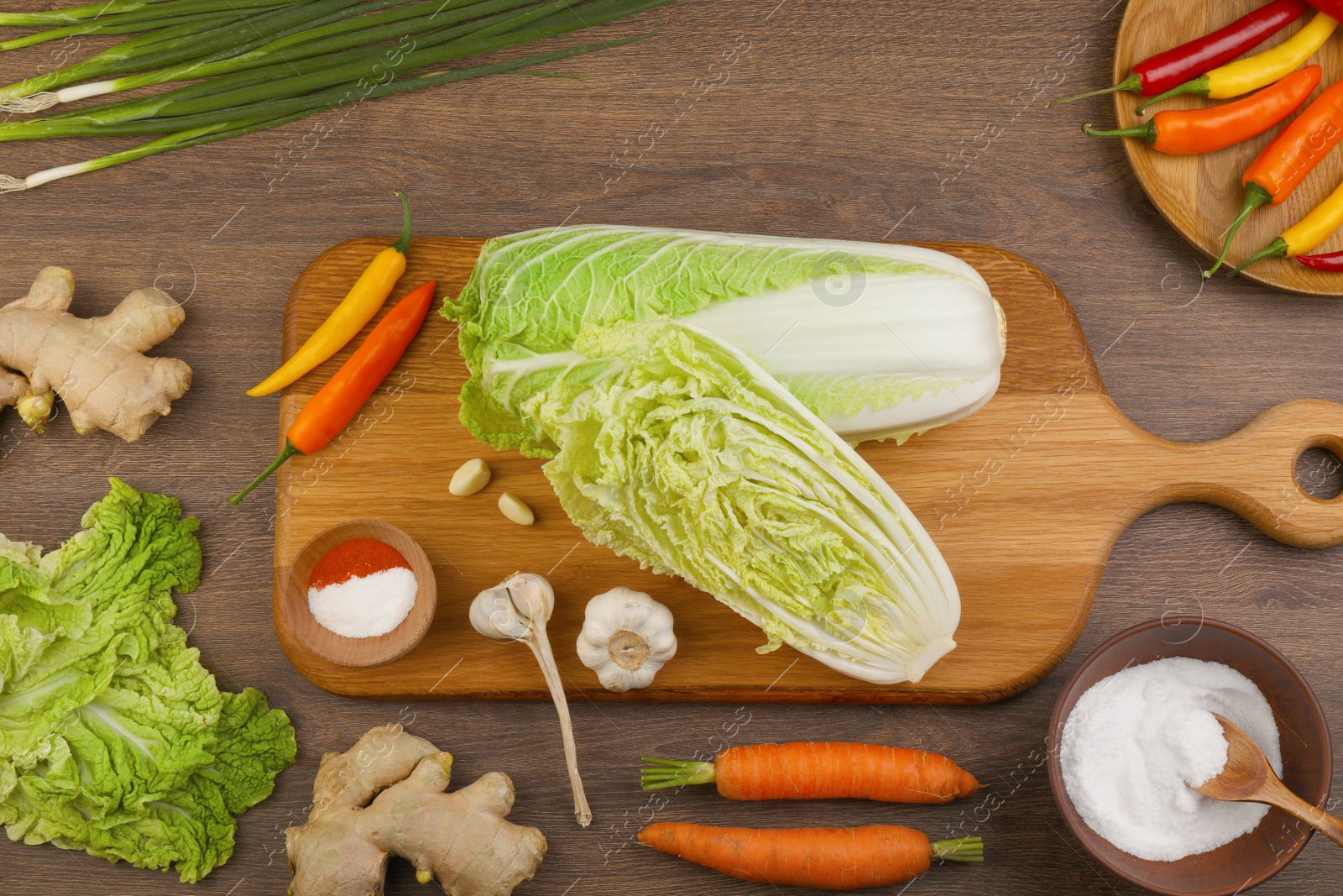 Photo of Flat lay composition with fresh Chinese cabbages and ingredients on wooden table