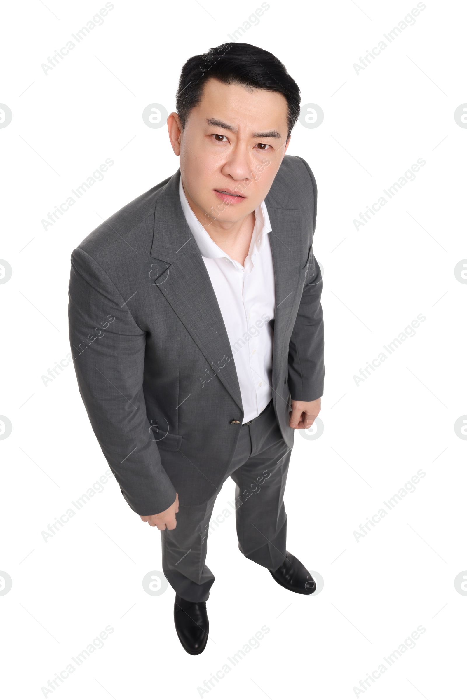 Photo of Angry businessman in suit posing on white background, above view