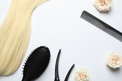 Photo of Flat lay composition with different hairdresser tools and flowers on white background, space for text