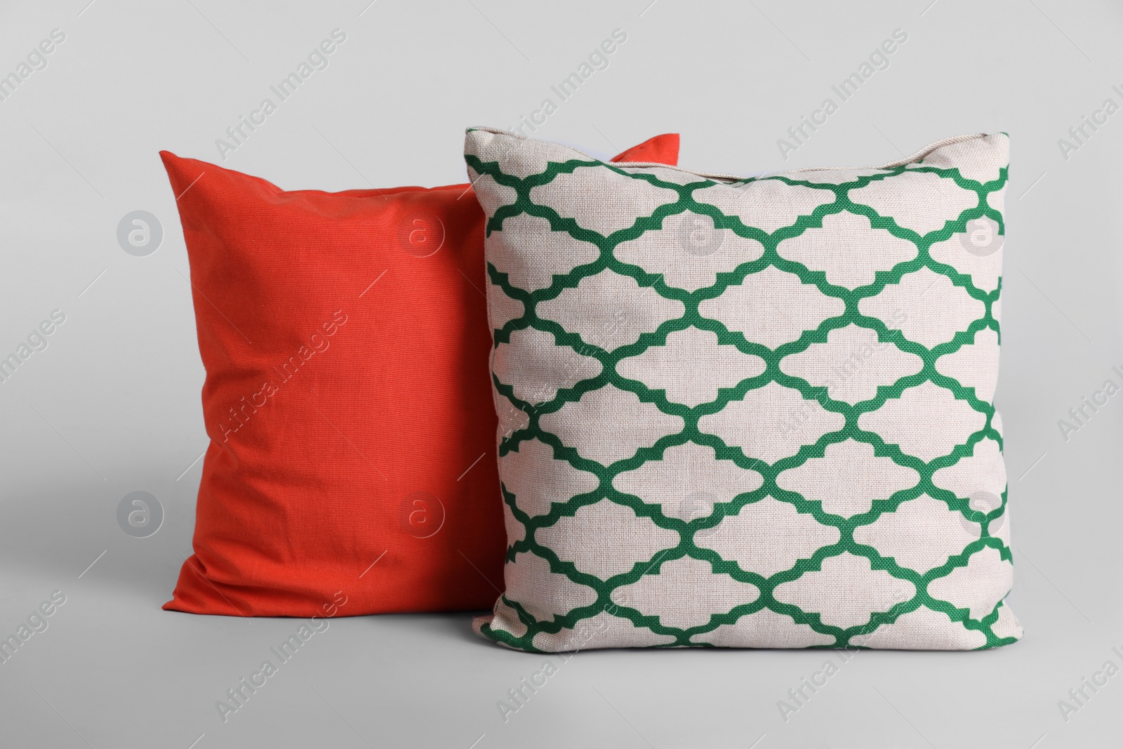 Photo of Different stylish soft pillows on grey background