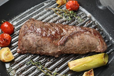 Photo of Delicious grilled beef meat and vegetables in pan, closeup