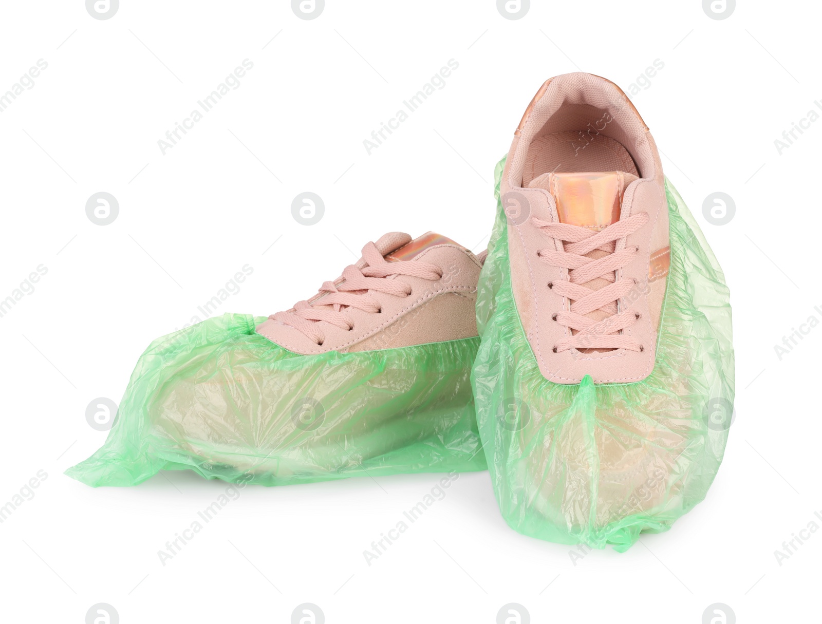 Photo of Sneakers in green shoe covers isolated on white