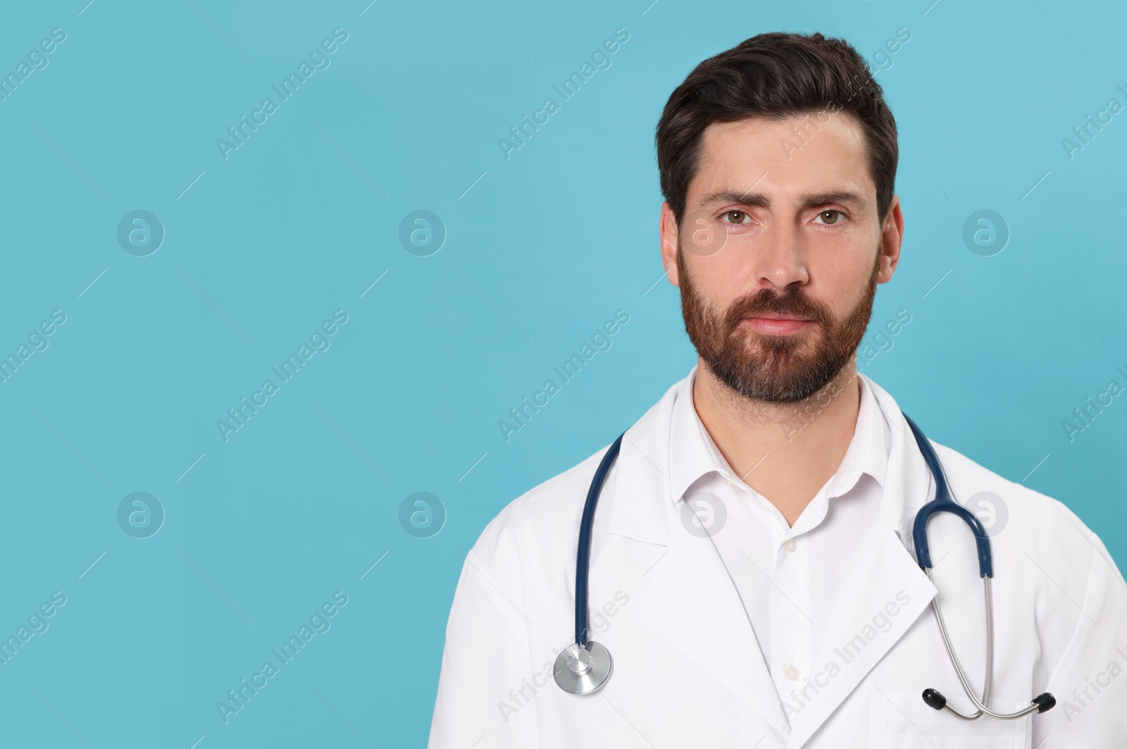 Photo of Nurse in medical uniform with stethoscope on light blue background, space for text