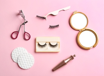 Photo of Flat lay composition with magnetic eyelashes and accessories on pink background