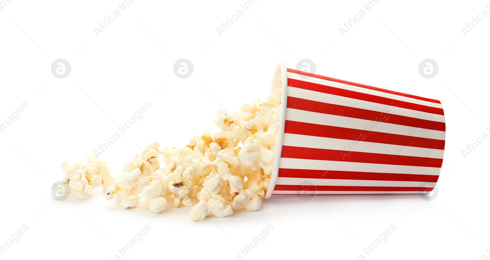 Photo of Overturned cup with delicious fresh popcorn on white background