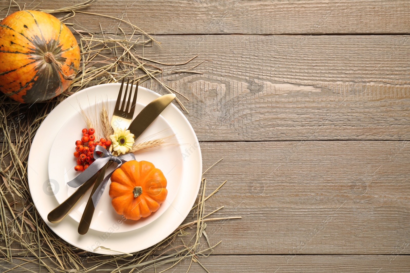 Photo of Festive table setting on wooden background, flat lay with space for text. Thanksgiving Day celebration