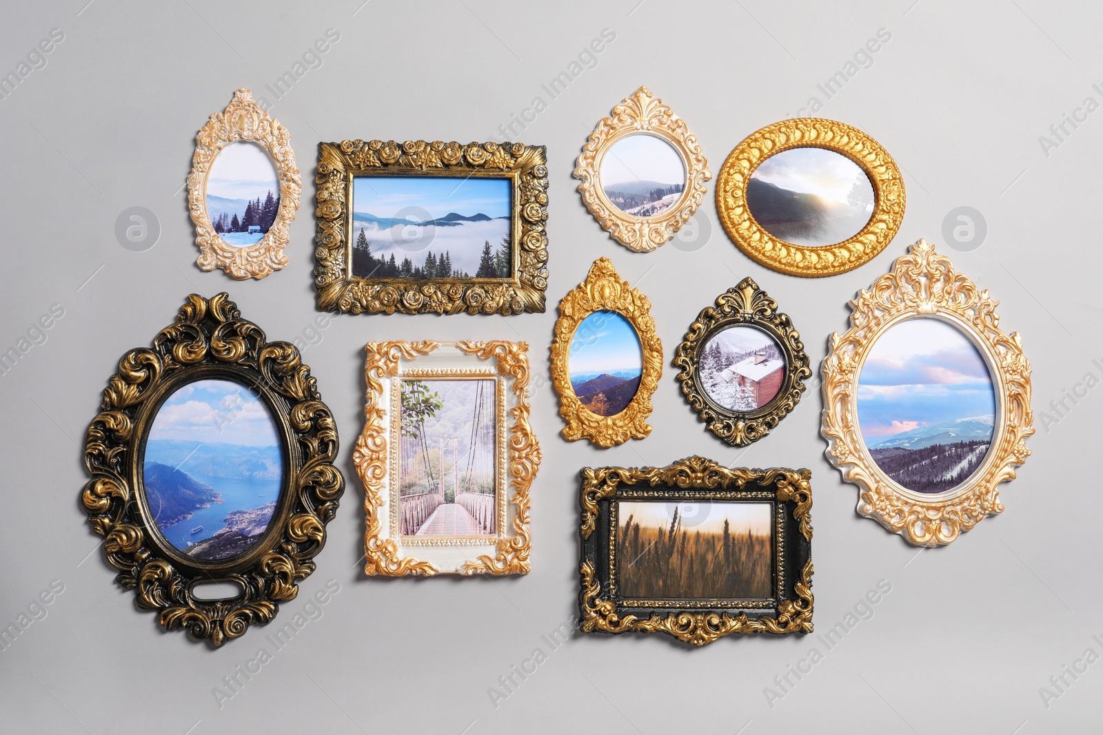 Photo of Vintage frames with beautiful photos of landscapes hanging on light gray wall