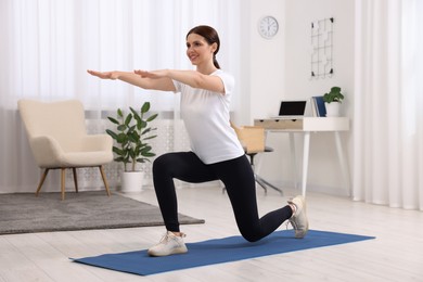 Photo of Happy woman doing morning exercise at home