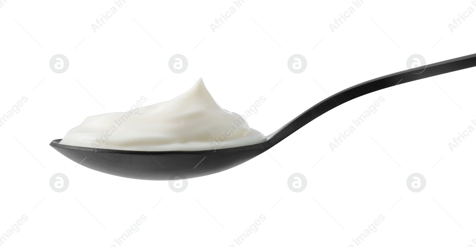 Photo of One black spoon with sour cream isolated on white