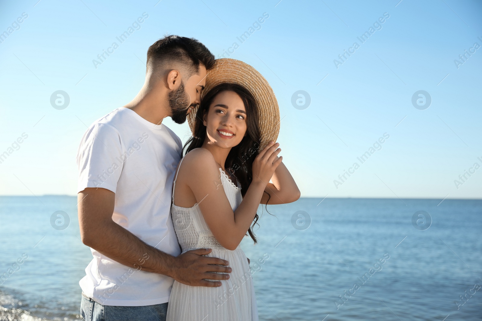 Photo of Happy young couple at beach. Honeymoon trip