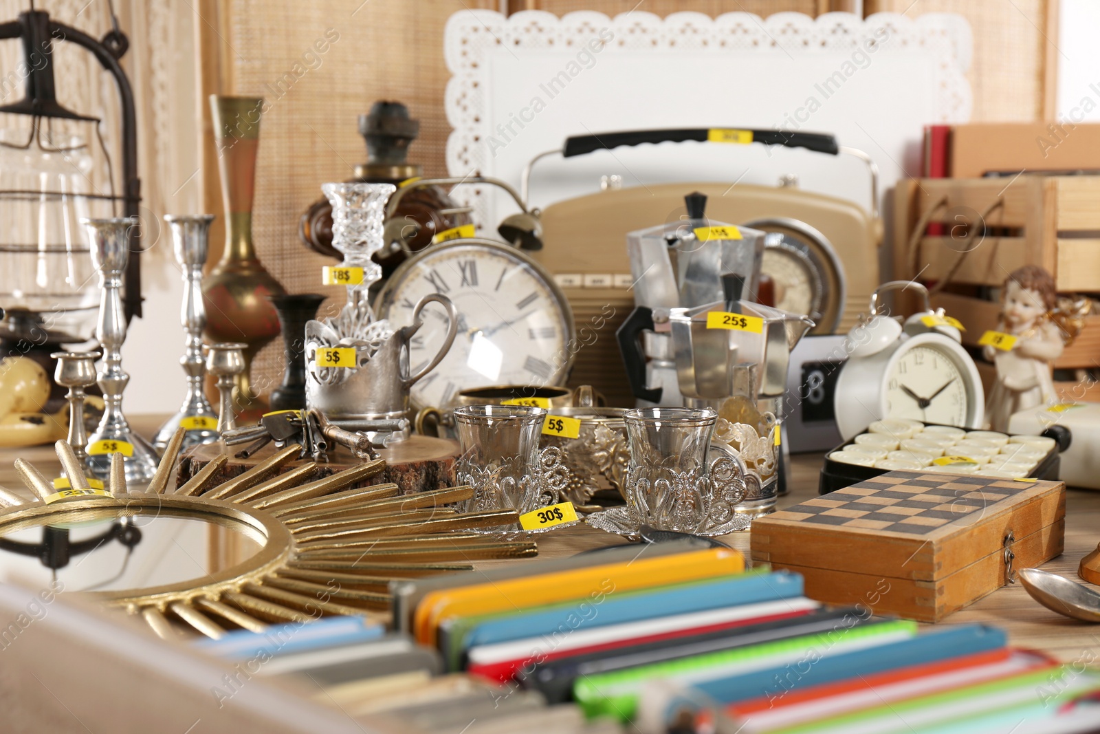 Photo of Many different items on wooden table. Garage sale