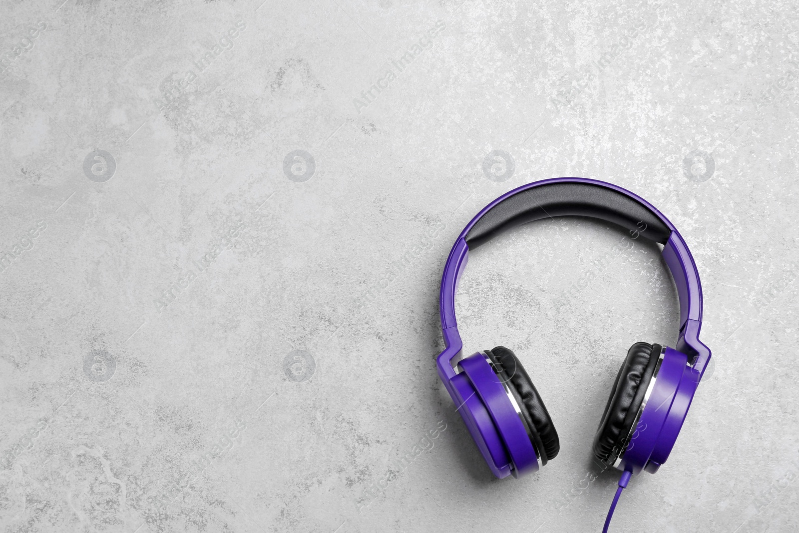 Photo of Stylish headphones on grey background, top view. Space for text