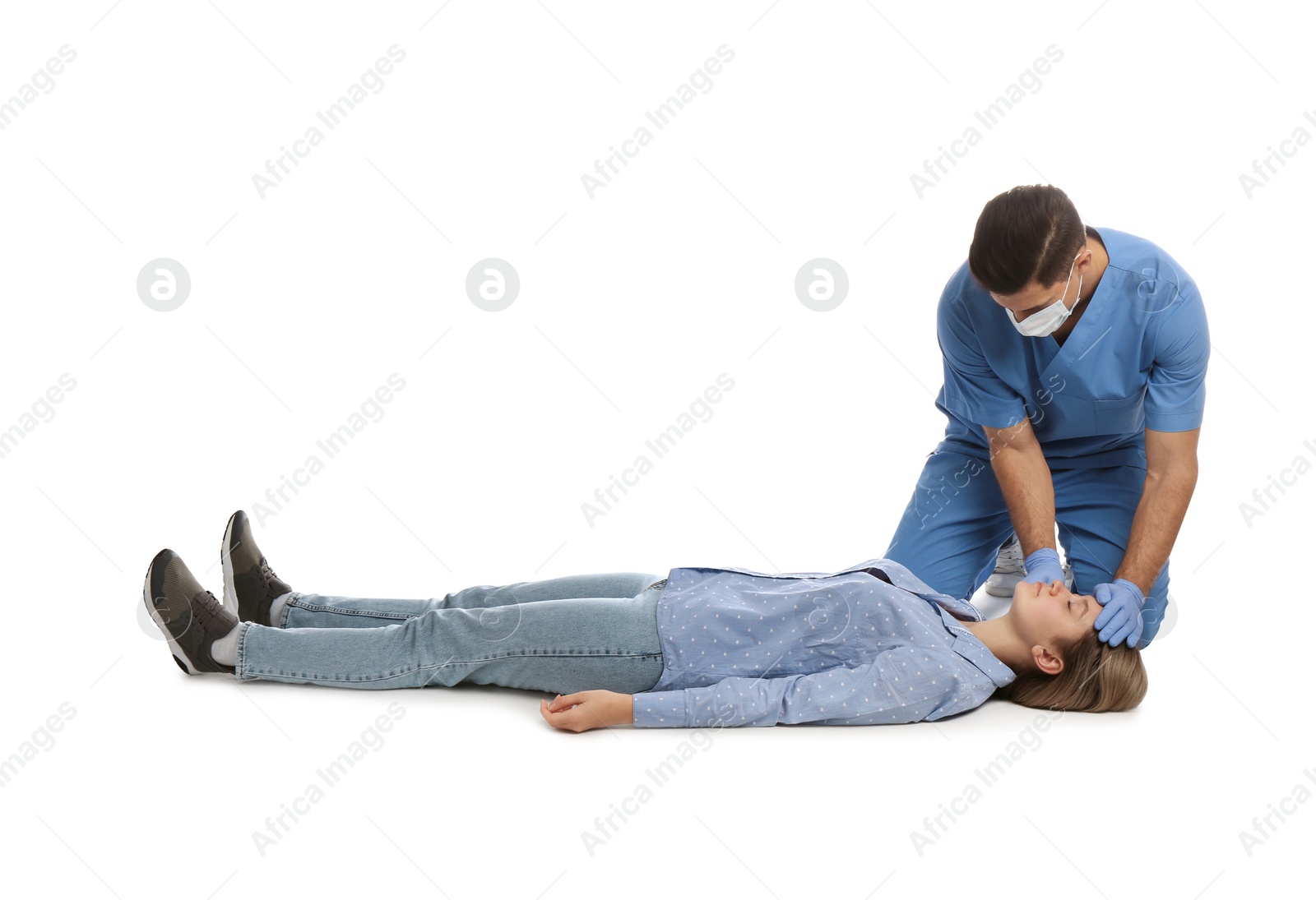 Photo of Doctor in uniform practicing first aid on woman against white background