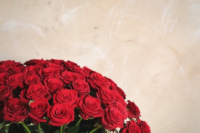 Photo of Luxury bouquet of fresh red roses on light background, space for text