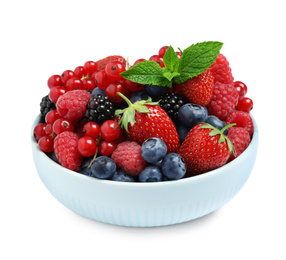 Mix of different fresh berries and mint in bowl on white background