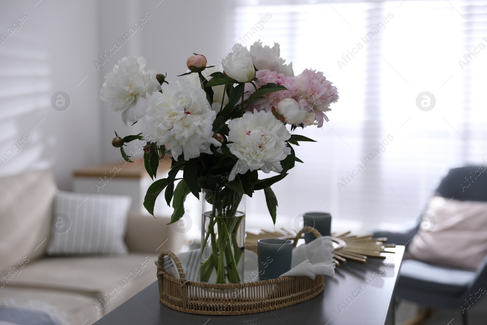 Photo of Bouquet of beautiful peony flowers on table indoors