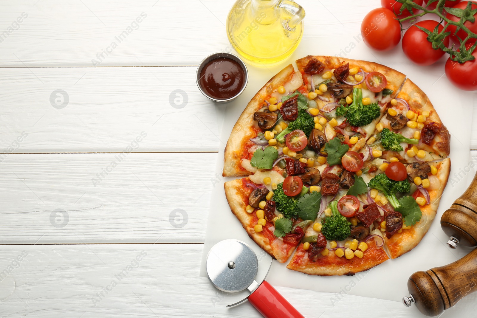 Photo of Delicious vegetarian pizza served on white wooden table, flat lay. Space for text