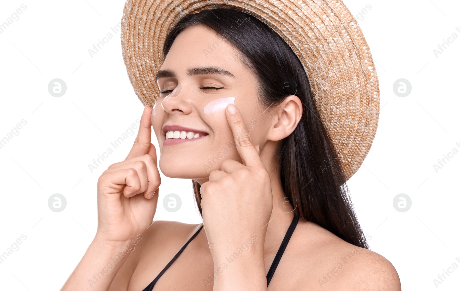 Photo of Beautiful young woman with sun protection cream on her face against white background