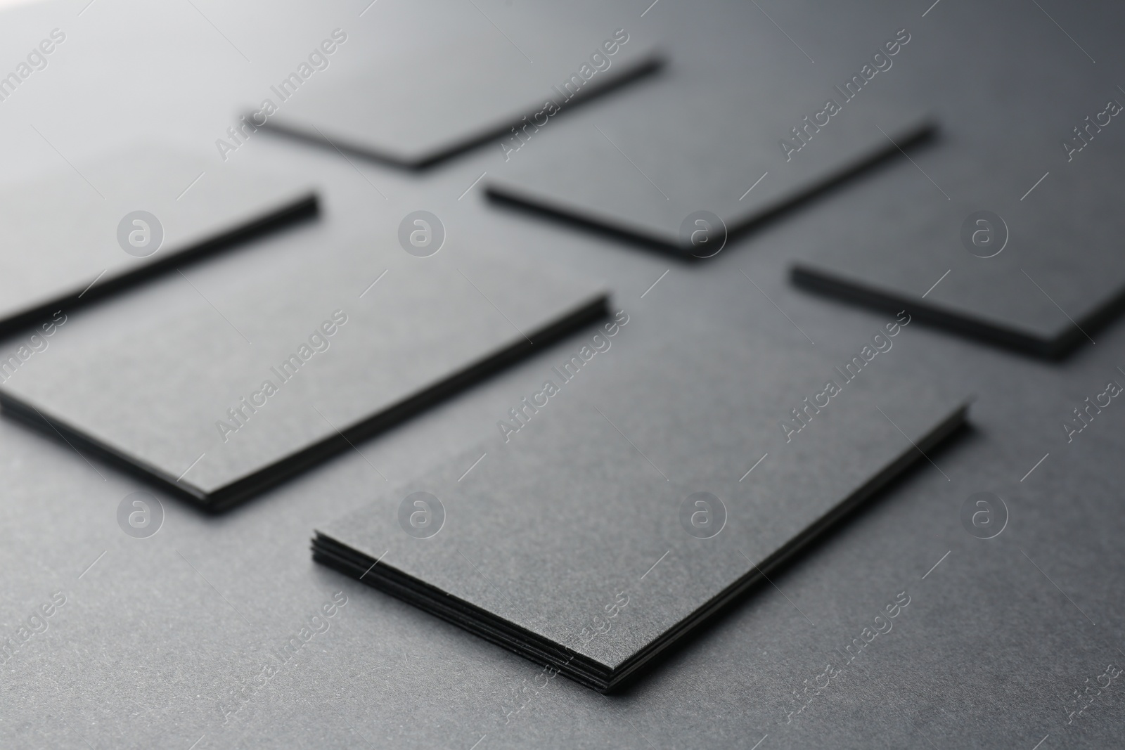 Photo of Blank business cards on black background, closeup. Mockup for design