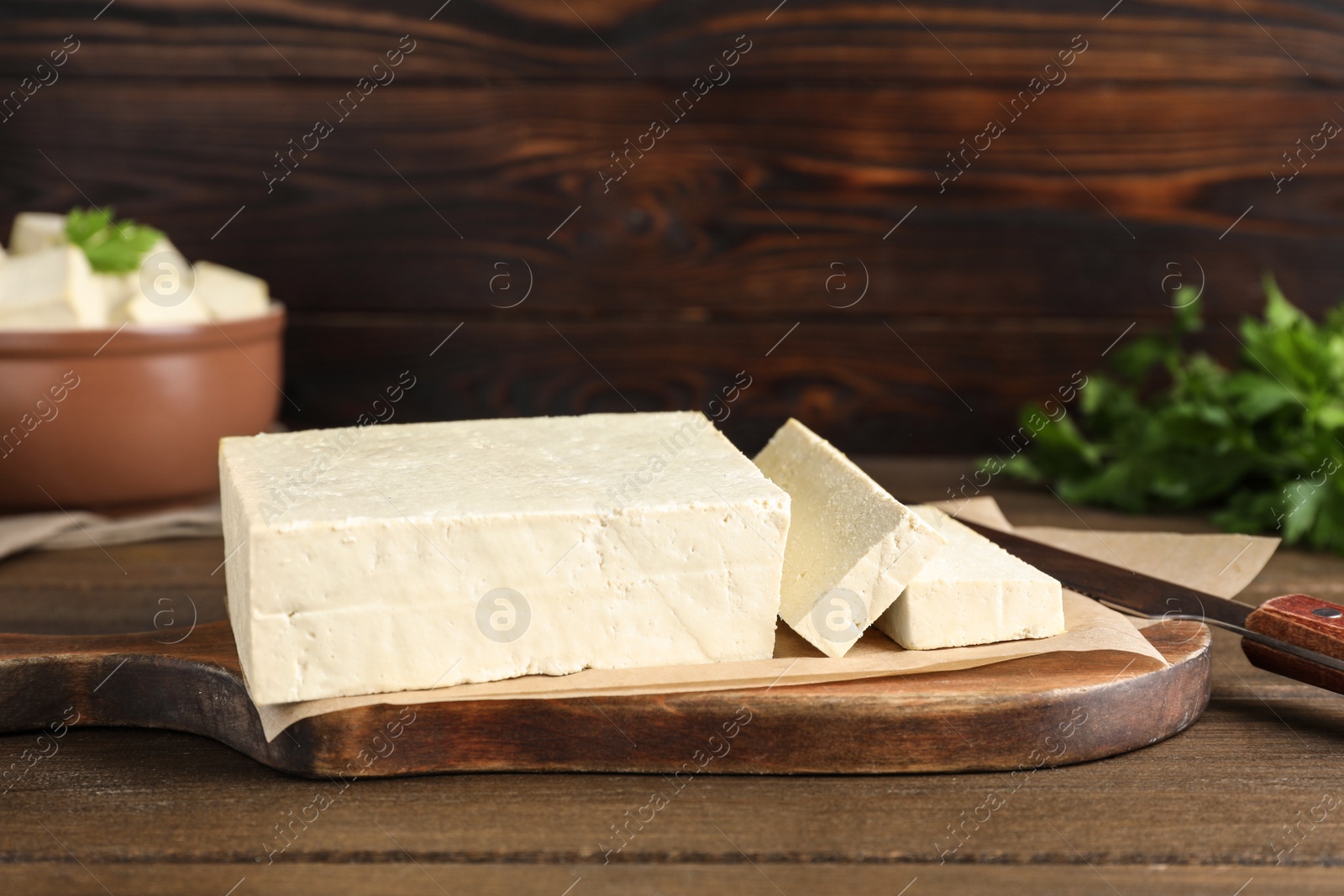 Photo of Piece of delicious tofu on wooden table