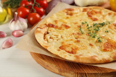Photo of Delicious khachapuri with cheese on white wooden table, closeup
