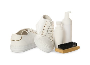 Stylish footwear and shoe care accessories on white background