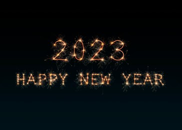 Image of 2023 Happy New Year made of sparkler on dark background. Greeting card design