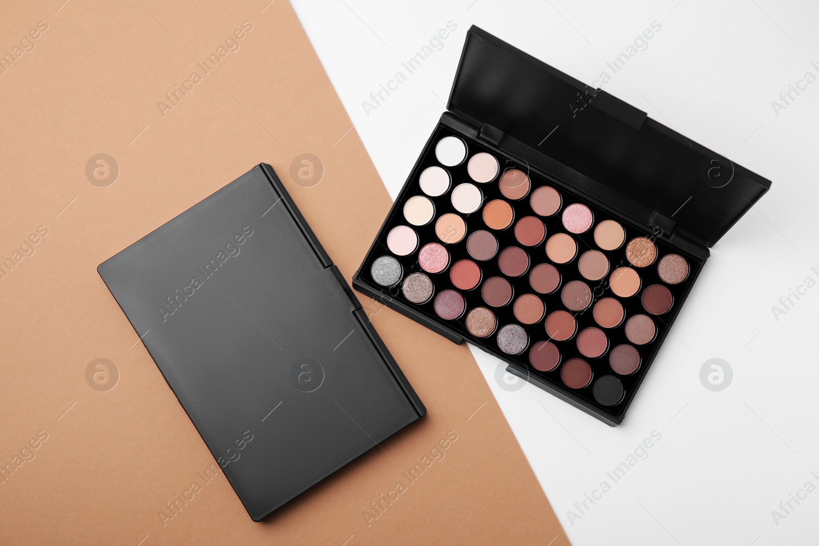 Photo of Eye shadow palettes on colorful background, flat lay