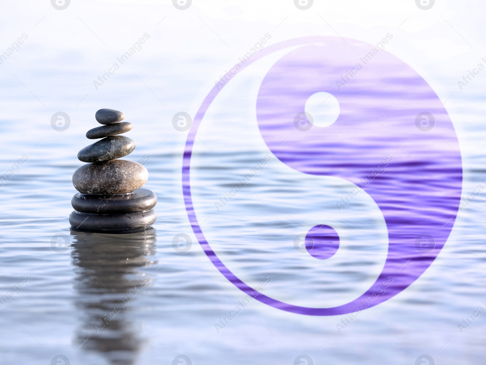 Image of Stack of stones in water and Ying Yang symbol. Feng Shui philosophy 