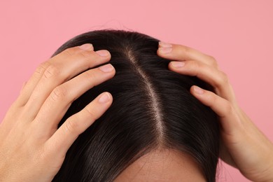 Woman with healthy hair on pink background, closeup