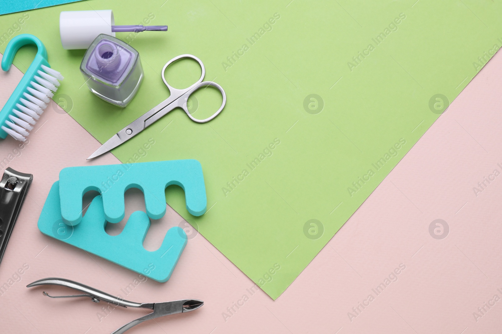 Photo of Set of pedicure tools on color background, flat lay. Space for text