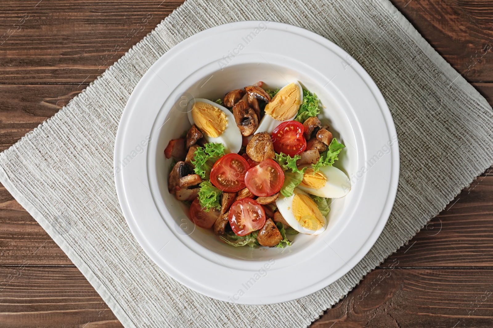 Photo of Plate with delicious fresh salad on table, top view