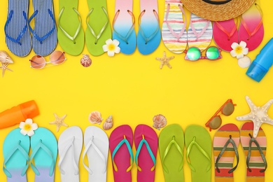 Photo of Flat lay composition with summer beach accessories on yellow background. Space for text