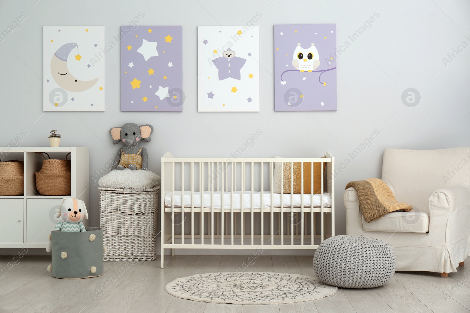 Photo of Baby room interior with crib and cute posters on wall