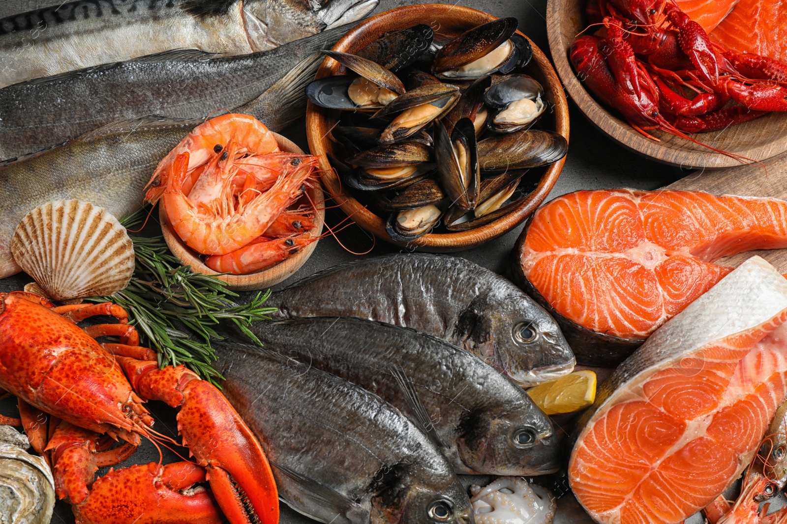 Photo of Fresh fish and different seafood on table, flat lay