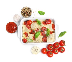 Tasty ravioli with tomato sauce and different ingredients on white background, flat lay