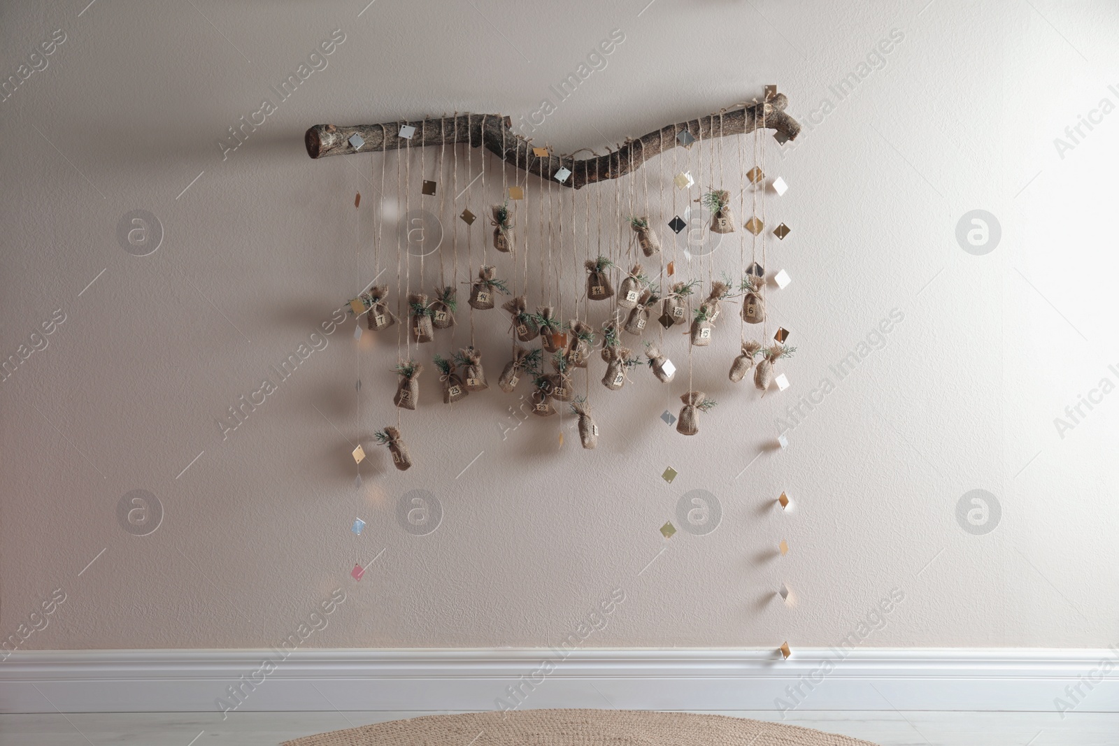 Photo of New Year advent calendar hanging on beige wall indoors