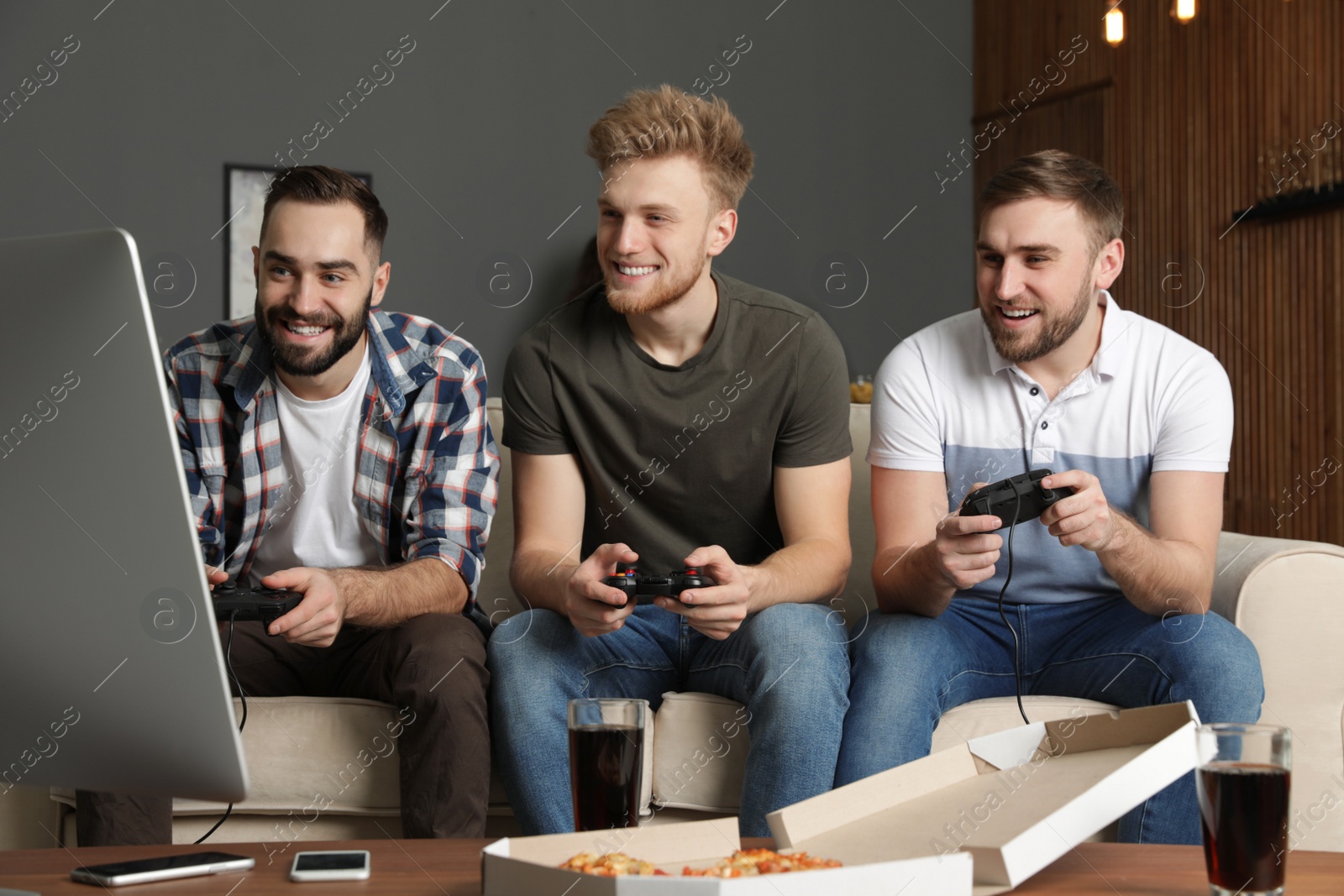 Photo of Emotional friends playing video games at home