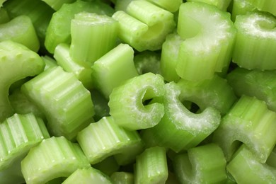 Photo of Fresh green cut celery as background, closeup