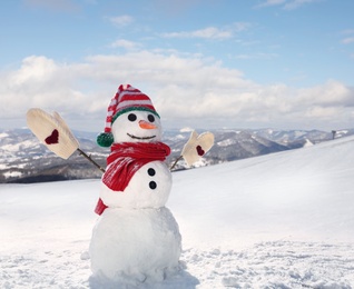 Image of Funny snowman outdoors on sunny day, space for text