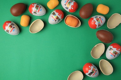 Photo of Sveti Vlas, Bulgaria - June 29, 2023: Kinder Surprise Eggs and plastic capsules on green background, flat lay. Space for text