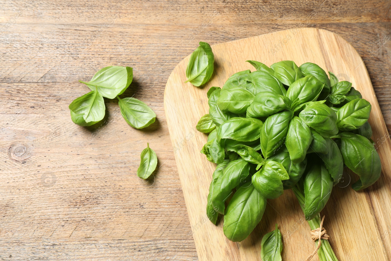 Photo of Fresh basil on wooden table, flat lay