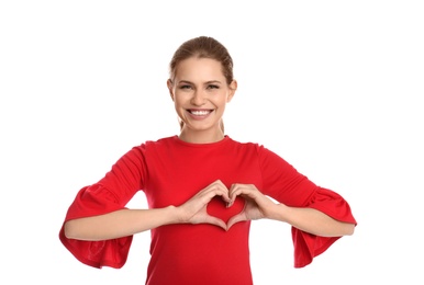 Portrait of young woman making heart with her hands on white background