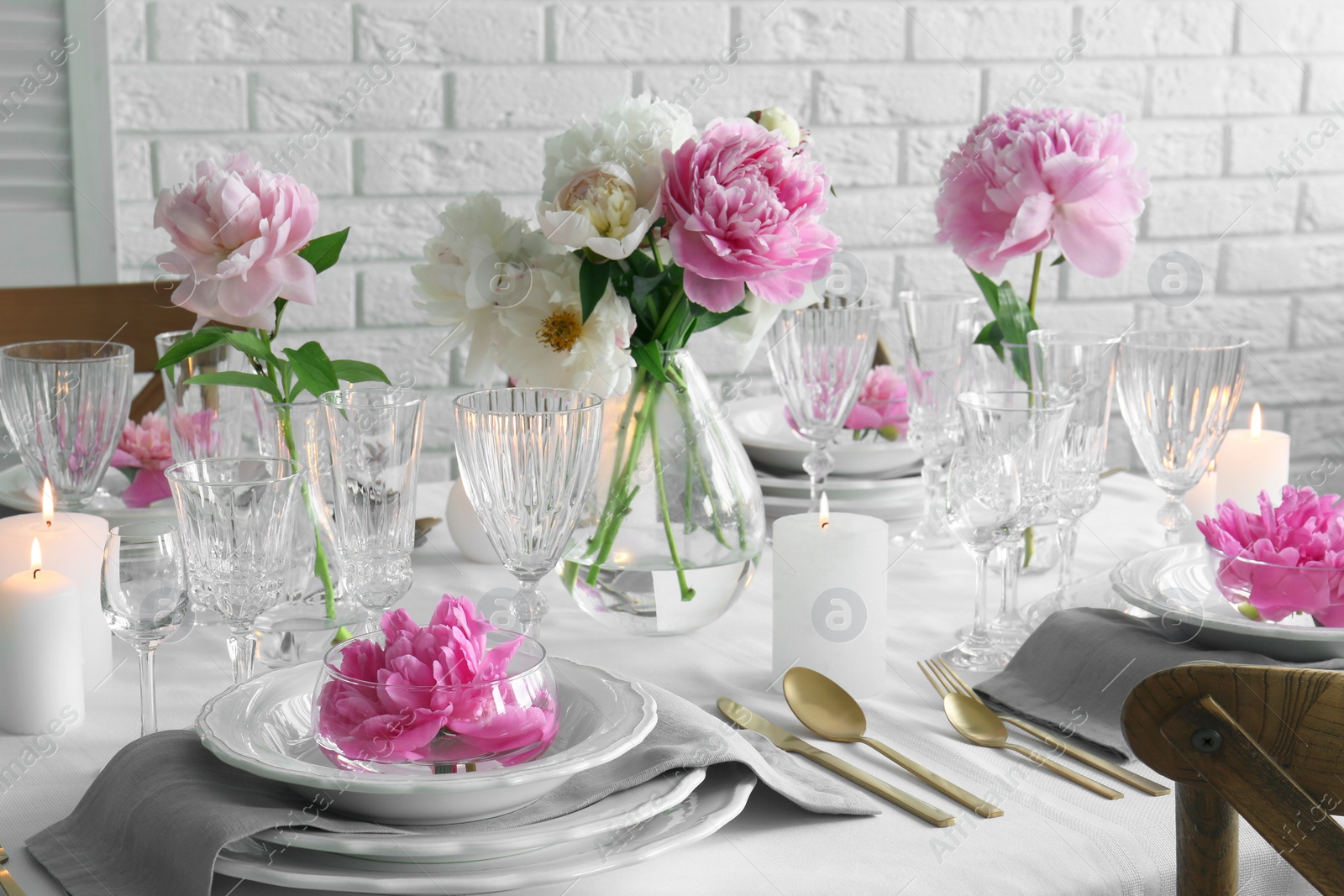 Photo of Stylish table setting with beautiful peonies in dining room