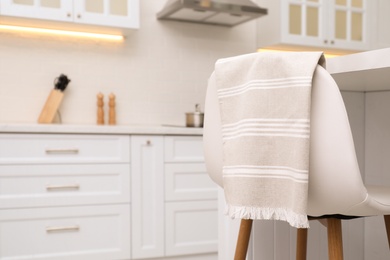 Clean kitchen towel on chair at home. Space for text