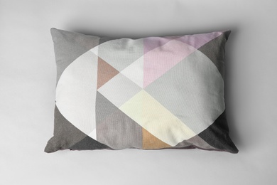 Photo of Soft decorative pillow on light background