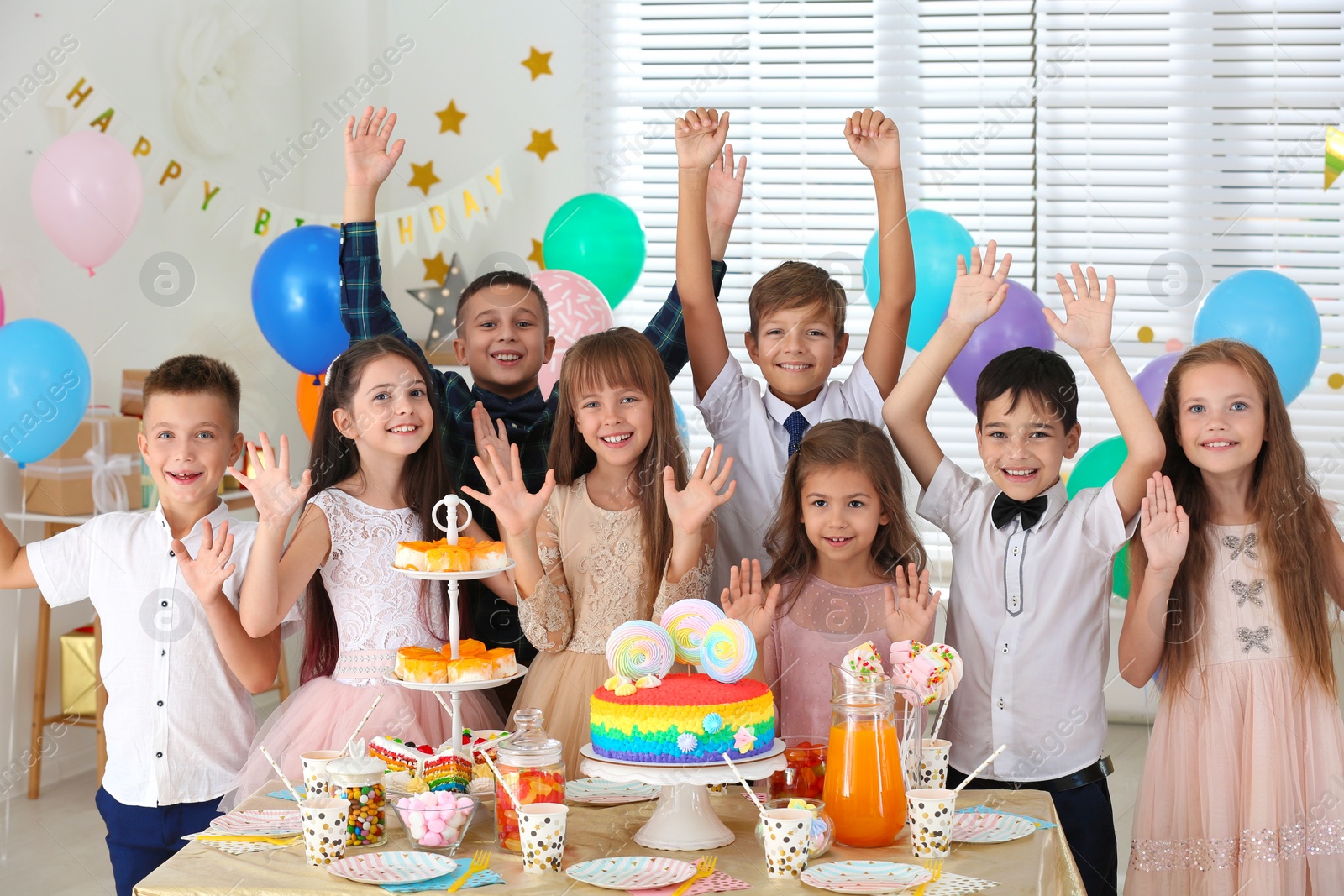 Photo of Happy children at birthday party in decorated room