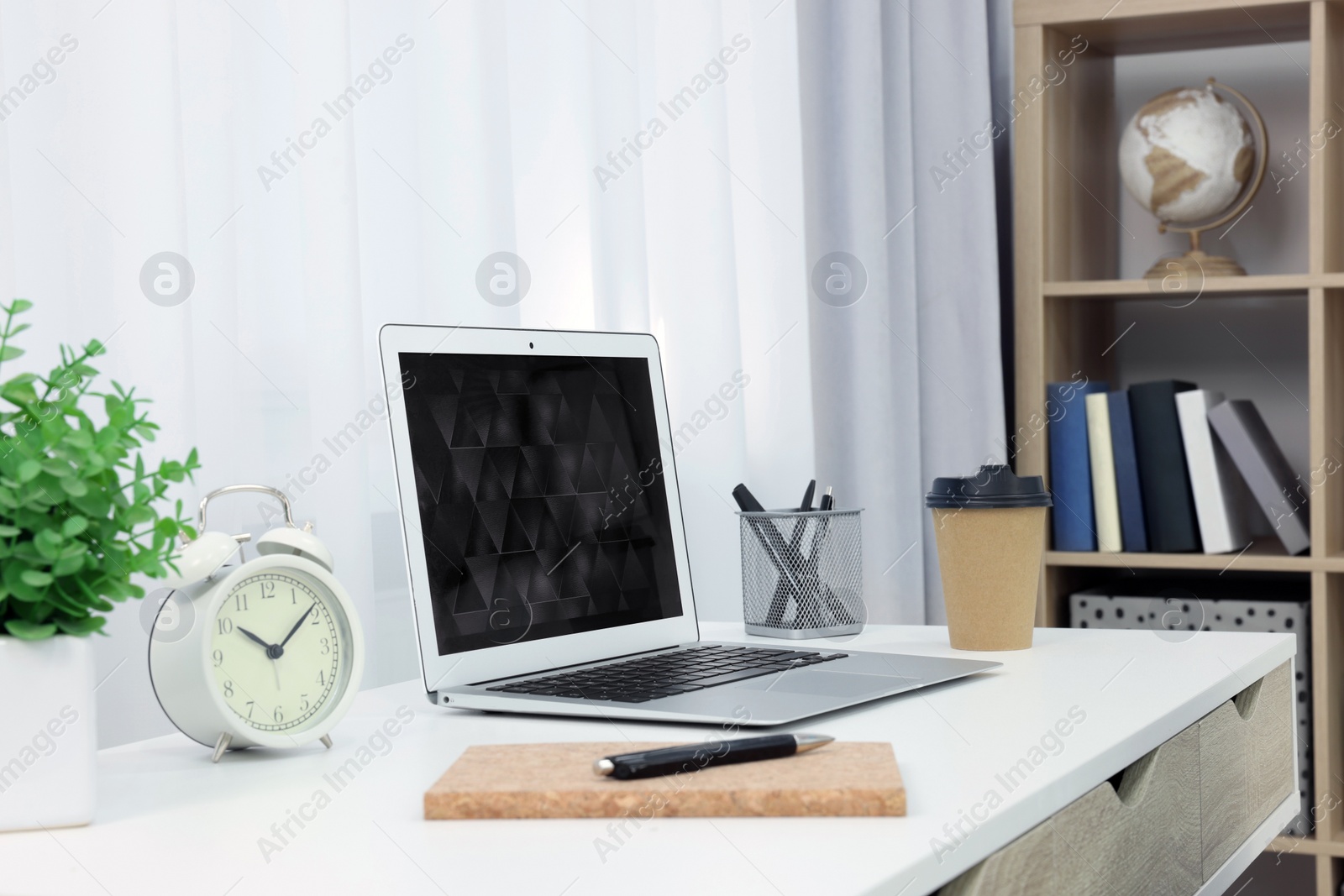 Photo of Workplace with modern laptop on desk at home