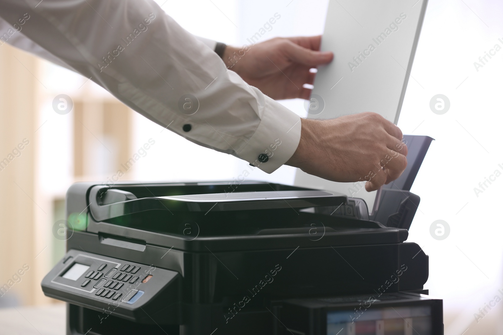 Photo of Employee using modern printer in office, closeup