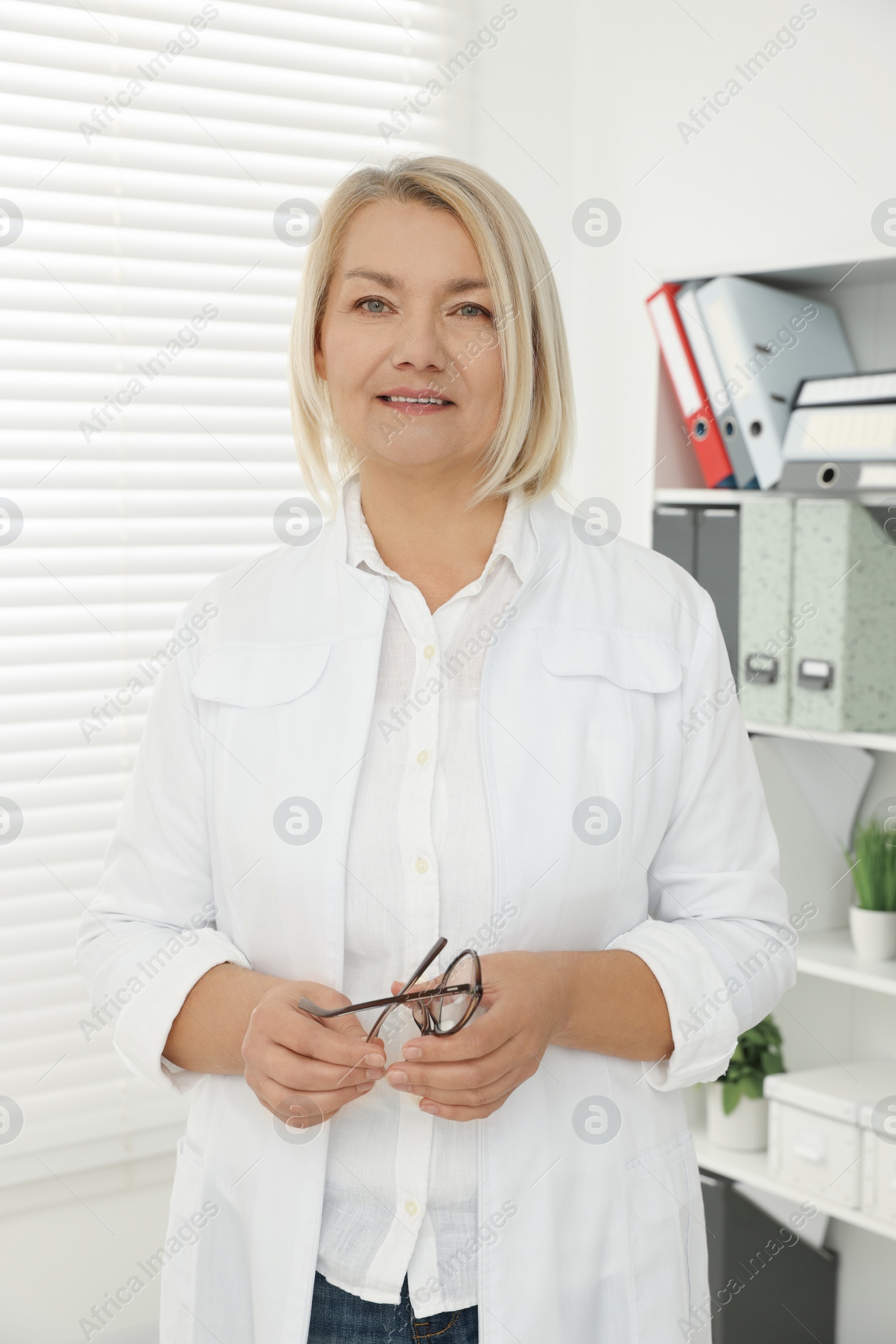 Photo of Professional doctor wearing medical coat in clinic